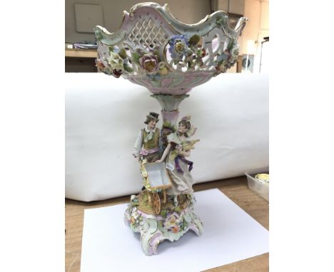 A European ceramic figural centrepiece/fruit bowl with two swords to the base, possibly Meissen. The base displaying a man wi