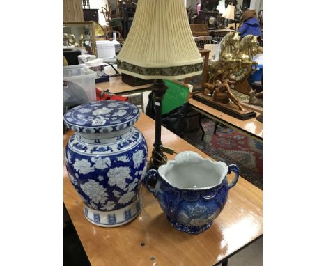 A 20th century Chinese ceramic blue and white garden seat a late Victorian blue and white Jardiniere and a modern table lamp 