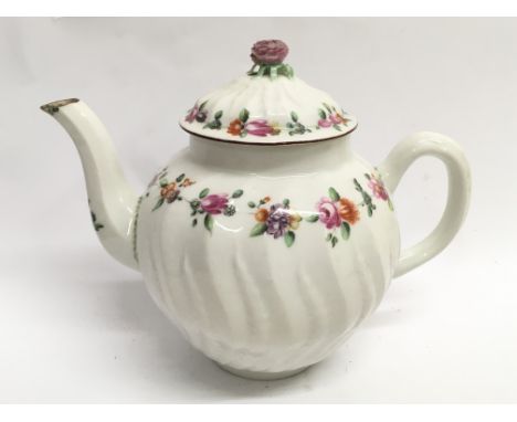 A 19th century teapot of fluted form with painted floral decoration, no stamp marks to the base.