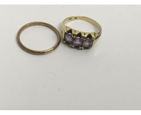 A 9 ct gold wedding band and a 14 ct gold ring with amethyst stones