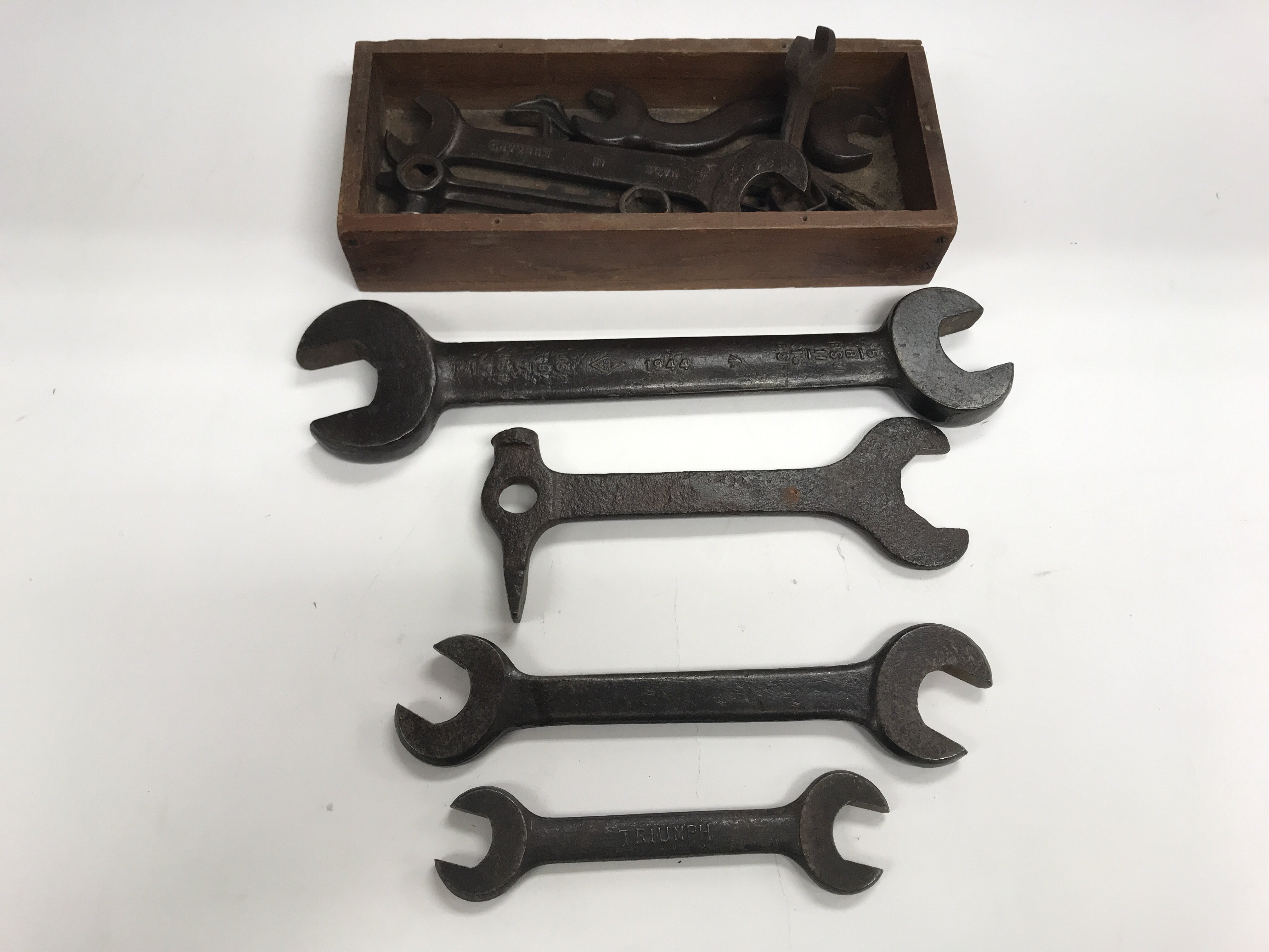 A box containing named British military spanner's.
