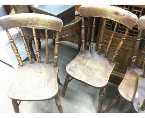 A set of four elm stick back chairs