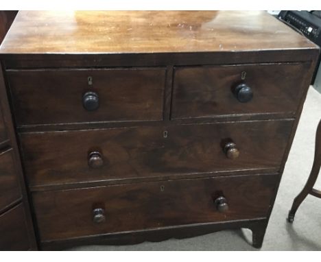 An Early Victorian Mahogany chest of drawers fitted with two short and two long drawers on bracket feet.