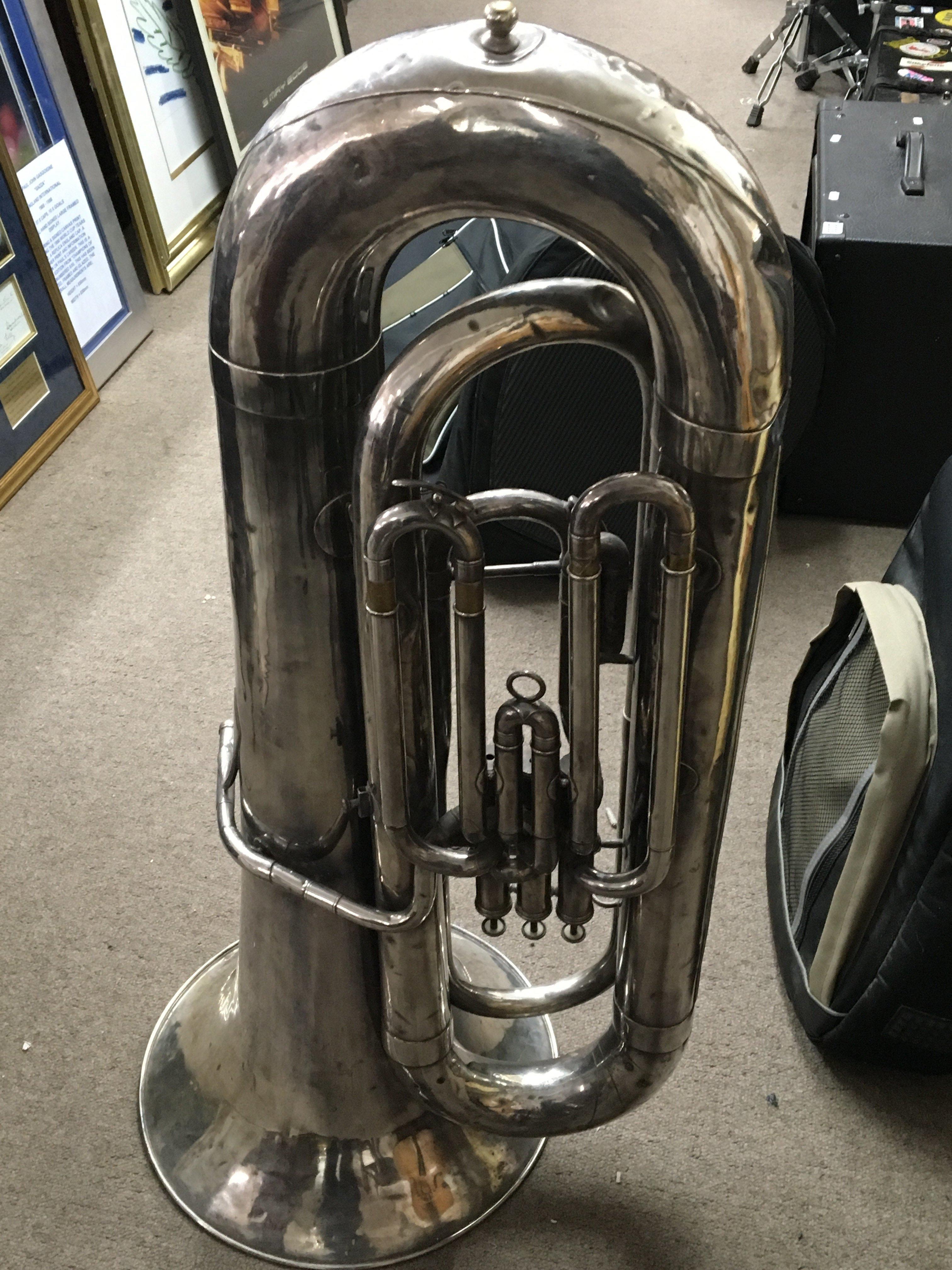 A Vintage Besson Tuba Silvered finish. In a later canvas case. Some dents.