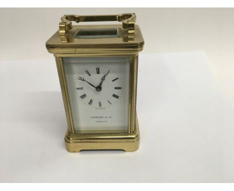 A brass carriage clock the enamel dial with Roman numerals