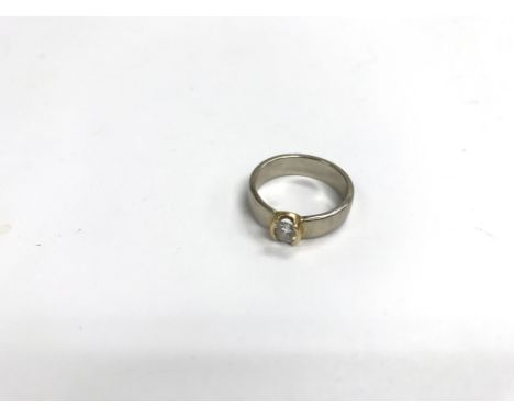 An unmarked gold ring set with a diamond. Weight approx 6g, size approx O