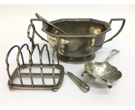 A collection of silver oddments to comprise of a miniature toast rack, a spoon, tea strainer, a sucrier and a small cigarette