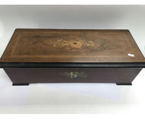 A Victorian musical box playing eight airs in working order with no damage to the comb. Size approx 63.5x26x18cm.