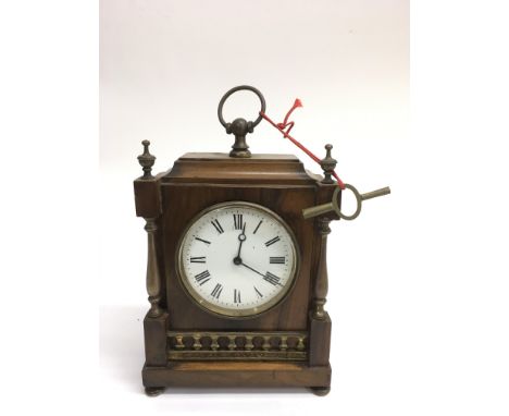 A wood and brass mantle clock with Roman Numeral dial and key.Approx 15x19cm