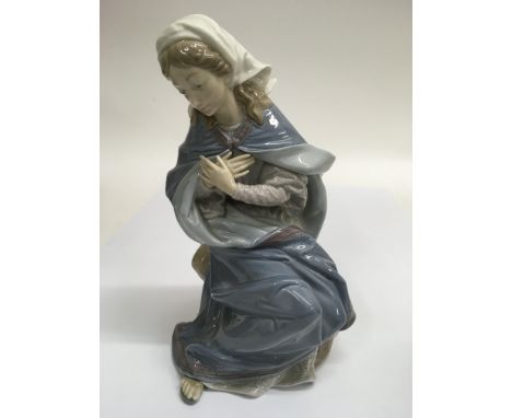 A Lladro figure of a young woman in contemplative pose, approx 25cm