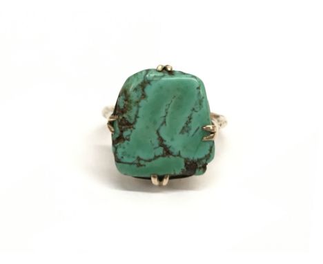 An antique gold ring set with a large turquoise stone. Ring size approx O/N, total weight approximately 5 grams.