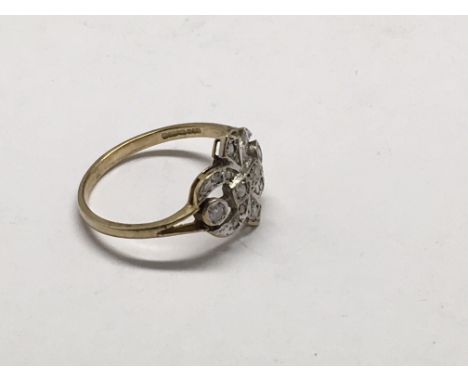 A 9ct gold ring with a Fleur de Lys diamond setting, approx O