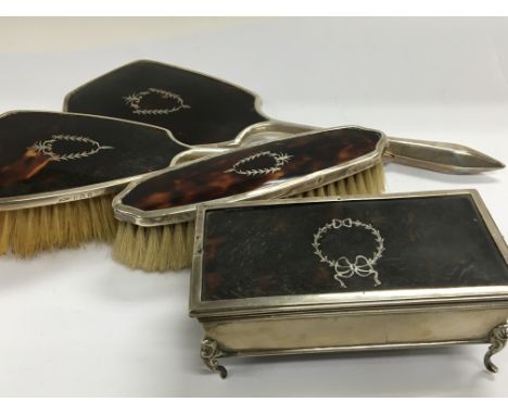 A silver and tortershell ring box of rectangular shape a similar silver and tortershell dressing table set