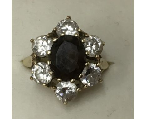 A 9ct gold ring set with folate design of smoked quartz and cubic zirconia.Approx size P/Q