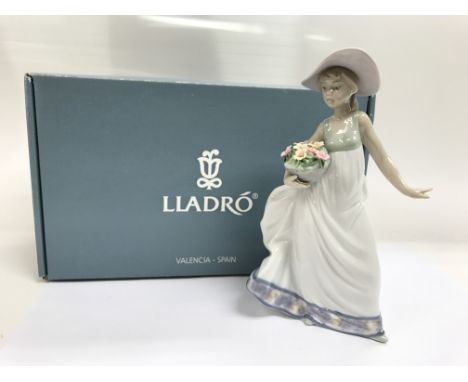 A boxed Lladro figure of a girl with flowers, 'Con Flores y Brisa: Carefree'