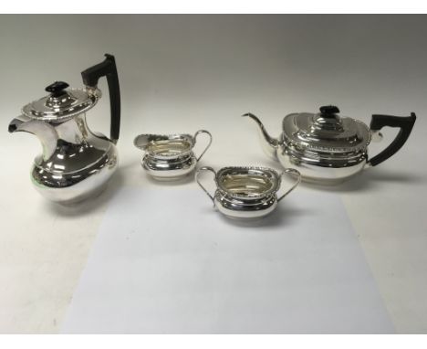 A four piece silver tea set including a coffee pot, a teapot and two jugs. Total approximate weight is 1,936 grams.