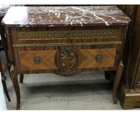 A French style Marquetry commode with a marble top with applied gilt metal mounts.