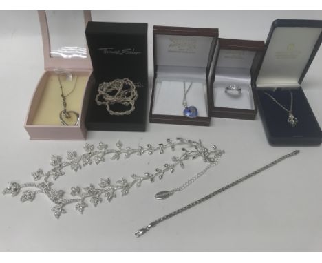 A collection of various silver jewellery including a ring, necklaces and a bracelet.