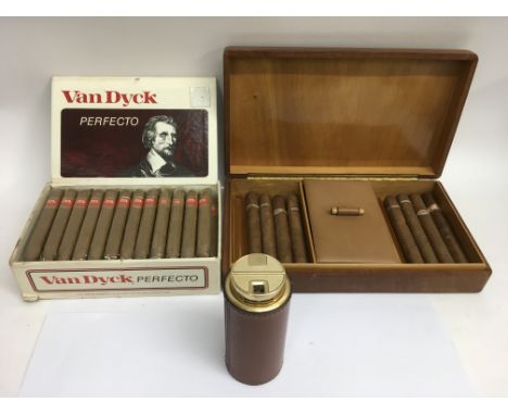 A vintage leather smoker's box with contents , a box of Van Dyck cigars' and a leather bound Delvaux table lighter