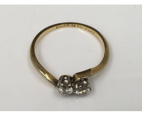 An 18ct gold, two stone diamond crossover ring