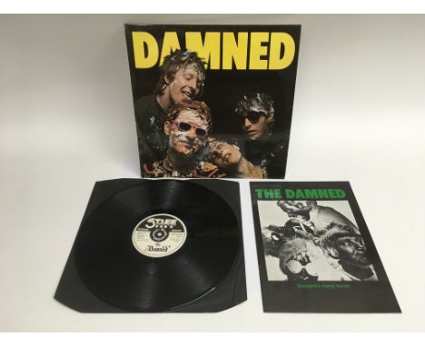 A first pressing of 'The Damned' LP on Stiff records, Seez 1 together with a a Damned disciples song book. Vinyl in excellent