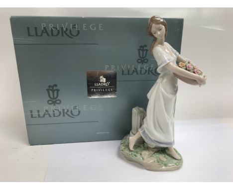 A boxed Lladro figure of a young lady gathering flowers, 'Jardines de Atenas: Gardens of Athens'.