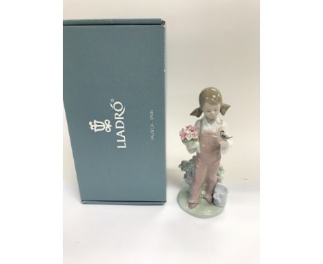 A boxed Lladro figure of a young girl with a songbird and flowers, 'Primavera Infantil: Spring'
