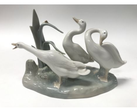A Lladro figure of three geese.