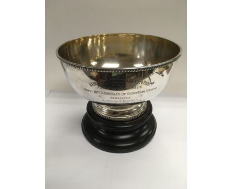 A silver circular bowl raised on a hardwood stand, the bowl bearing inscription for first prize winner of the Bath and county