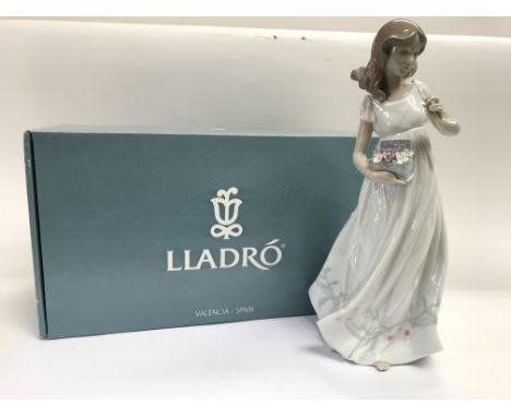 A boxed Lladro figure of a young lady gathering flowers, 'Tesoros de la Tierra: Treasures of The Earth '.