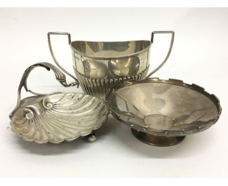 A silver shell dish, a silver sucrier hallmarked Chester 1914 and a third silver shallow bowl. Total weight approximately 350