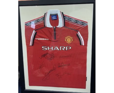 Manchester United 1998 - 1999 Treble Winners Signed Framed Shirt: Signed by seven players including Beckham. Frame measures a
