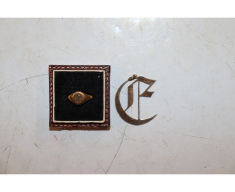 A 9ct gold pendant in the form of Old English E, Approx. 1.5g and a 9ct gold signet ring Approx. 2.2g