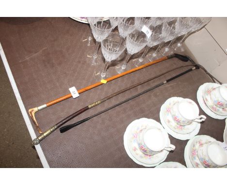 A ladies hunting whip with silver collars; a hunting whip with horn handle; and a leather side saddle whip with brass mounted