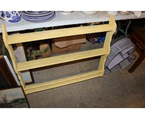 A yellow painted plate rack and a wicker storage shelf of heart form