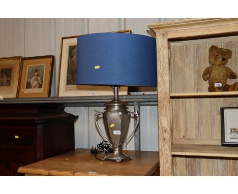 A modern metalware vine decorated table lamp with blue shade