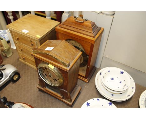 An early 20th Century oak and brass mounted mantel clock and another mantel clock