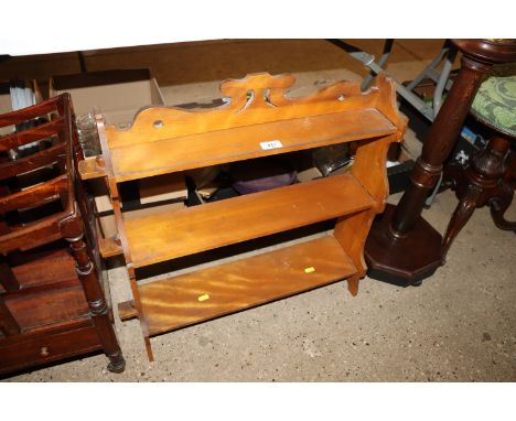 A lightwood pegged three tier wall shelf