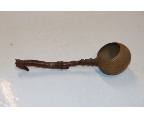 A treen water ladle with carved decoration