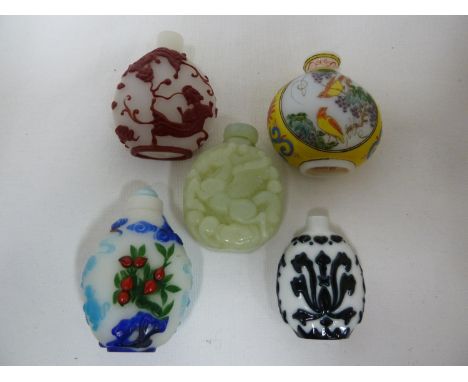 Chinese glass - five snuff bottles, one red cased glass over white cut with fighting dragons; one decorated in famille jaune 