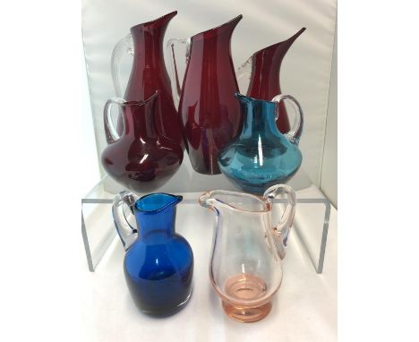 Whitefriars - Six glass jugs, 9419 ruby, in two sizes, 20cm and 17.5cm high; a 9620 ruby with angular colourless glass handle