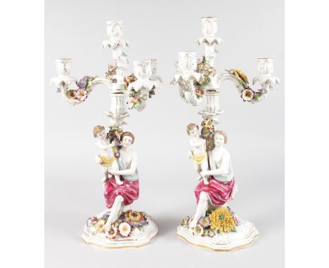 A VERY SIMILAR PAIR OF DRESDEN TYPE PORCELAIN FOUR LIGHT CANDELABRA, the base with classical young ladies holding a child. 19