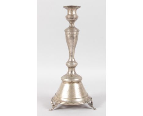 A CONTINENTAL SILVER CIRCULAR ENGRAVED CANDLESTICK on three winged feet. 12ins high.