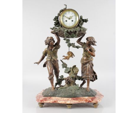 A 19TH CENTURY SPELTER FRENCH DRUM MANTLE CLOCK held aloft by a boy and girl standing on a serpentine fronted marble base. 26