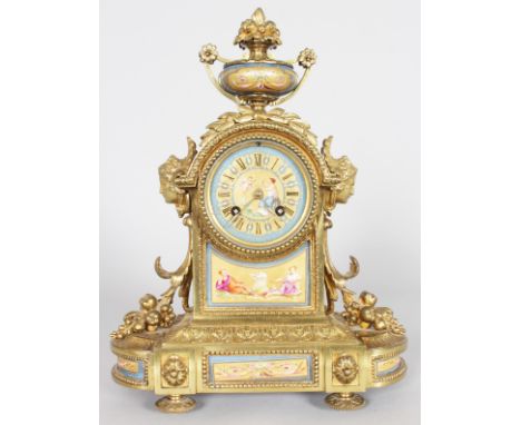 A GOOD 19TH CENTURY FRENCH GILT AND ORMOLU MANTLE CLOCK, with Sevres dial and panels, eight-day movement, the centre surmount