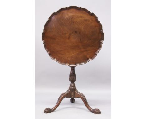 A CHIPPENDALE STYLE MAHOGANY TILT TOP TRIPOD TABLE, with a pierced top, carved column support on three carved legs with paw f