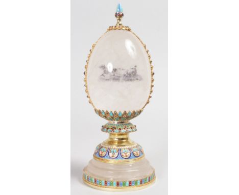 A VERY GOOD RUSSIAN SILVER, ENAMEL AND ROCK CRYSTAL EGG, on a circular base. 10ins high.