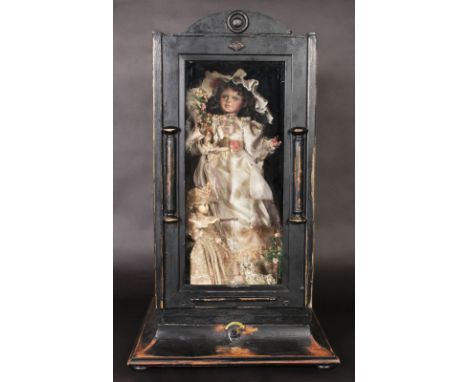 A 19TH CENTURY FRENCH CASED AUTOMATON, a doll in a wedding dress, small child playing with a dog. Case 31ins high.