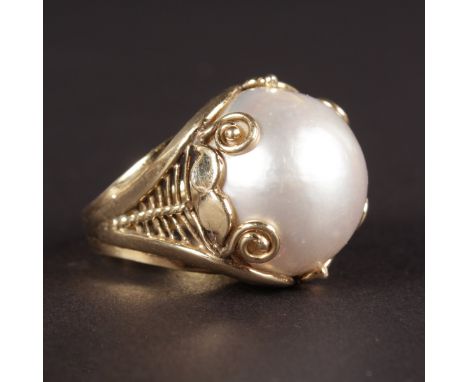 A LARGE PEARL RING set in 14k yellow gold.