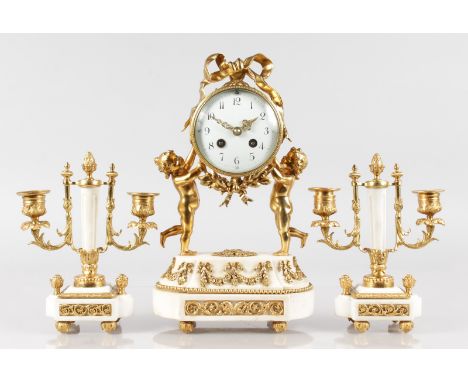 A SMALL LOUIS XVI DESIGN WHITE MARBLE AND GILT METAL THREE PIECE CLOCK GARNITURE, the clock with drum movement  held by two c